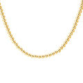 Gold beaded necklace on a white background