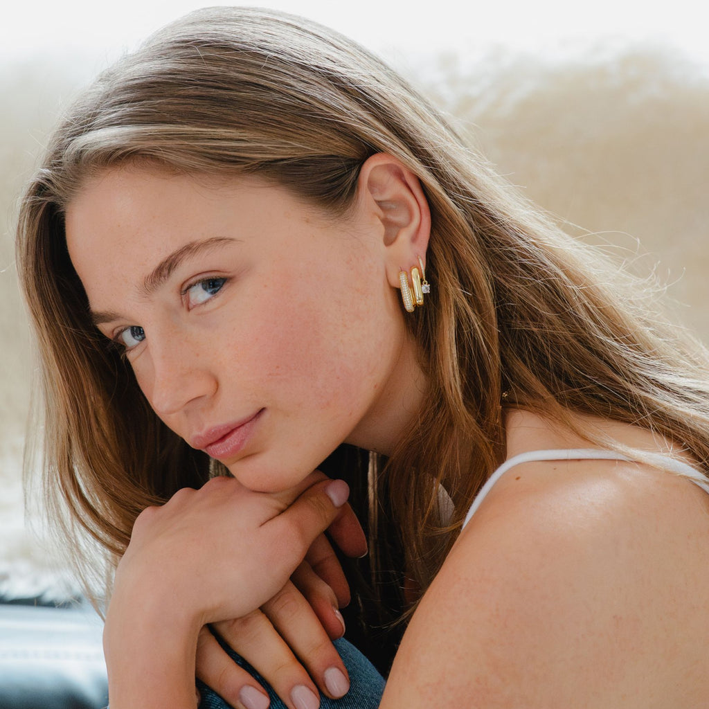 Sparkling pave U-shaped gold earrings styled for a statement look