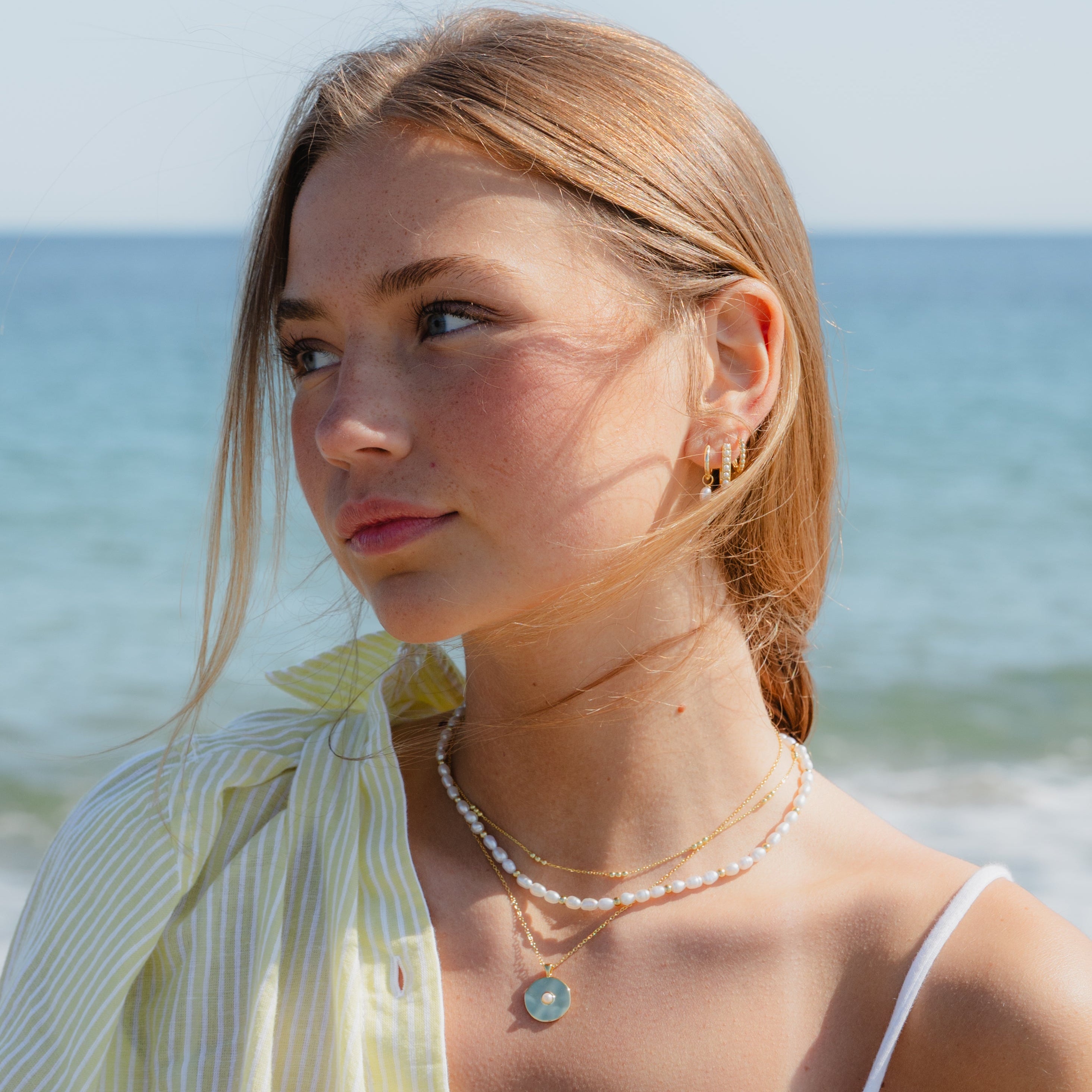 Stacked gold and pearl necklaces styled for everyday sophistication