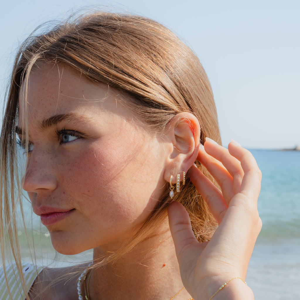  Earrings styled with swept-back hair
