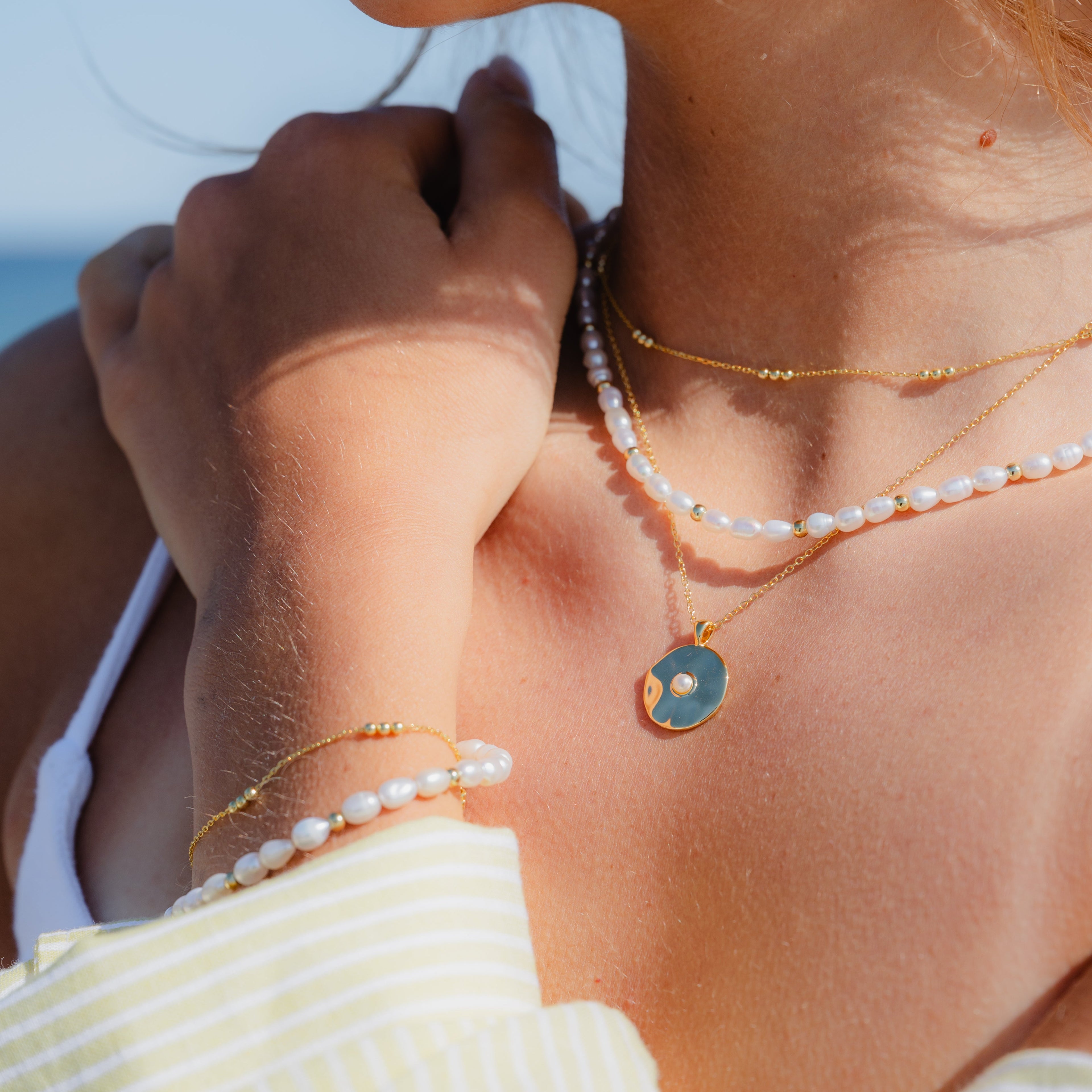 Mini gold bead station bracelet on model, stacked for everyday style