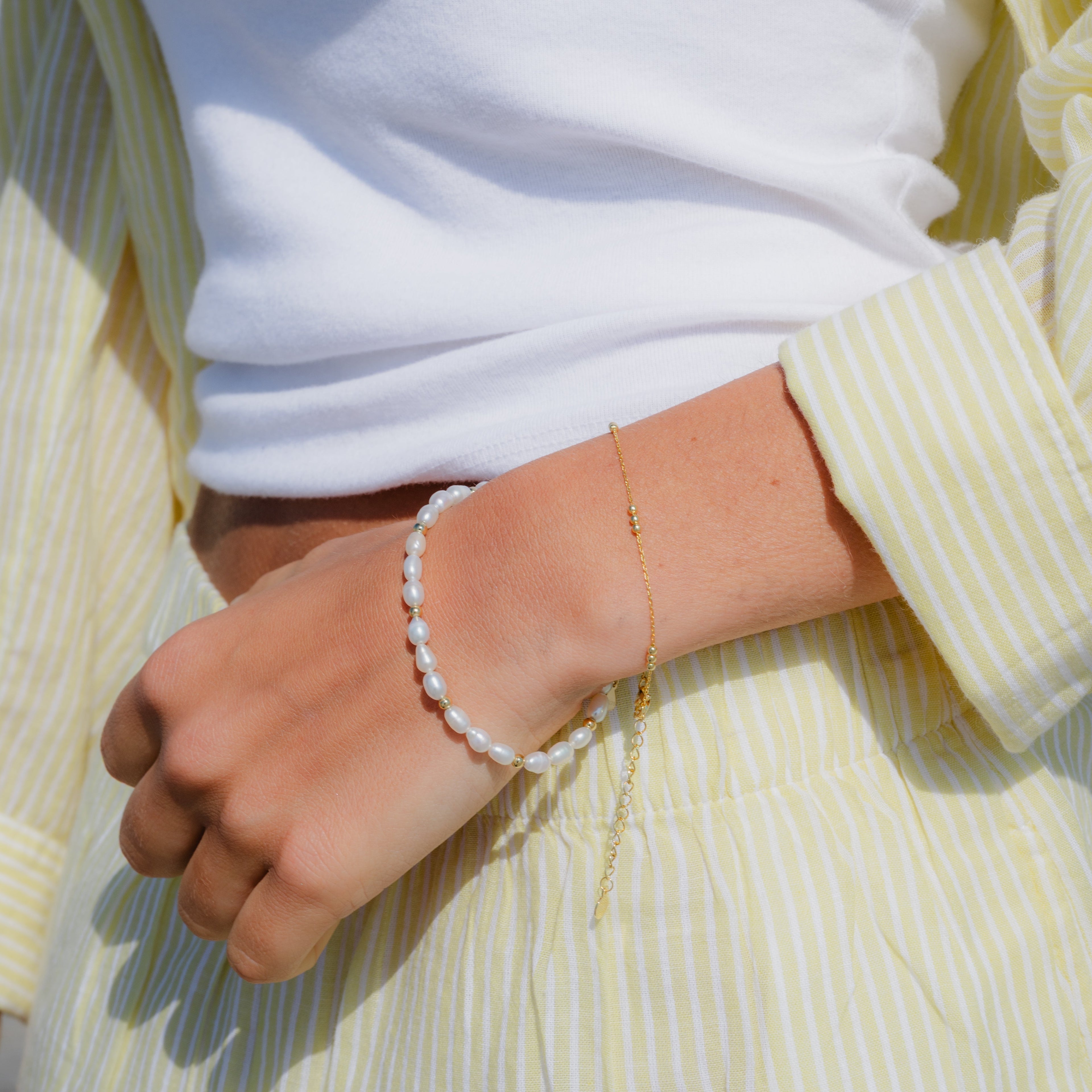Delicate gold and pearl bracelet styled for everyday elegance