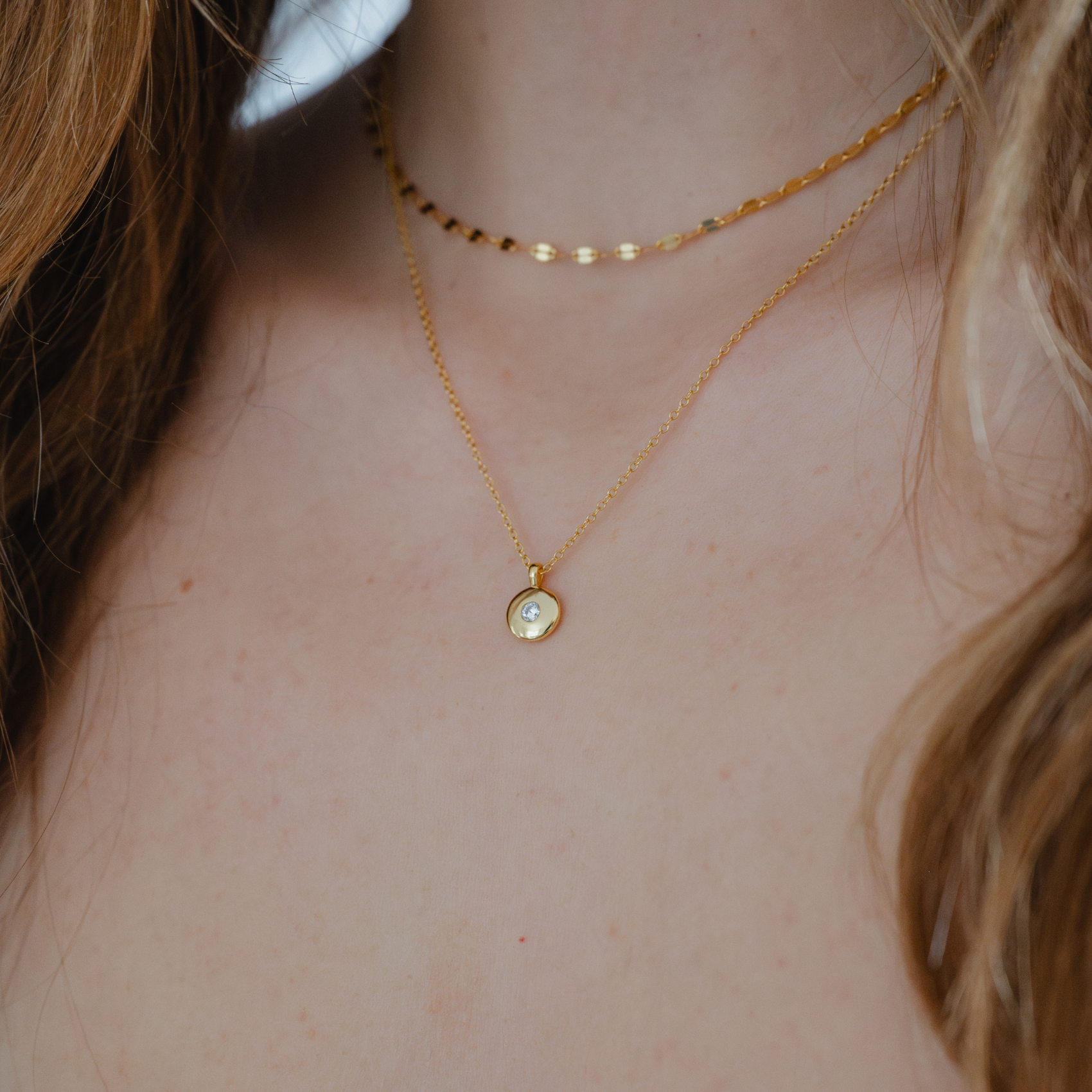 CZ gold round pendant necklace worn by model, simple and elegant

