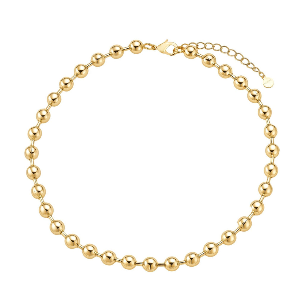 Gold beaded bracelet on a white background