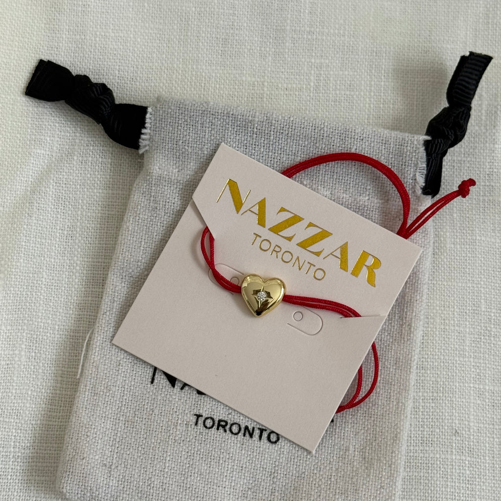 Delicate red bracelet presented in stylish gift packaging, perfect for gifting