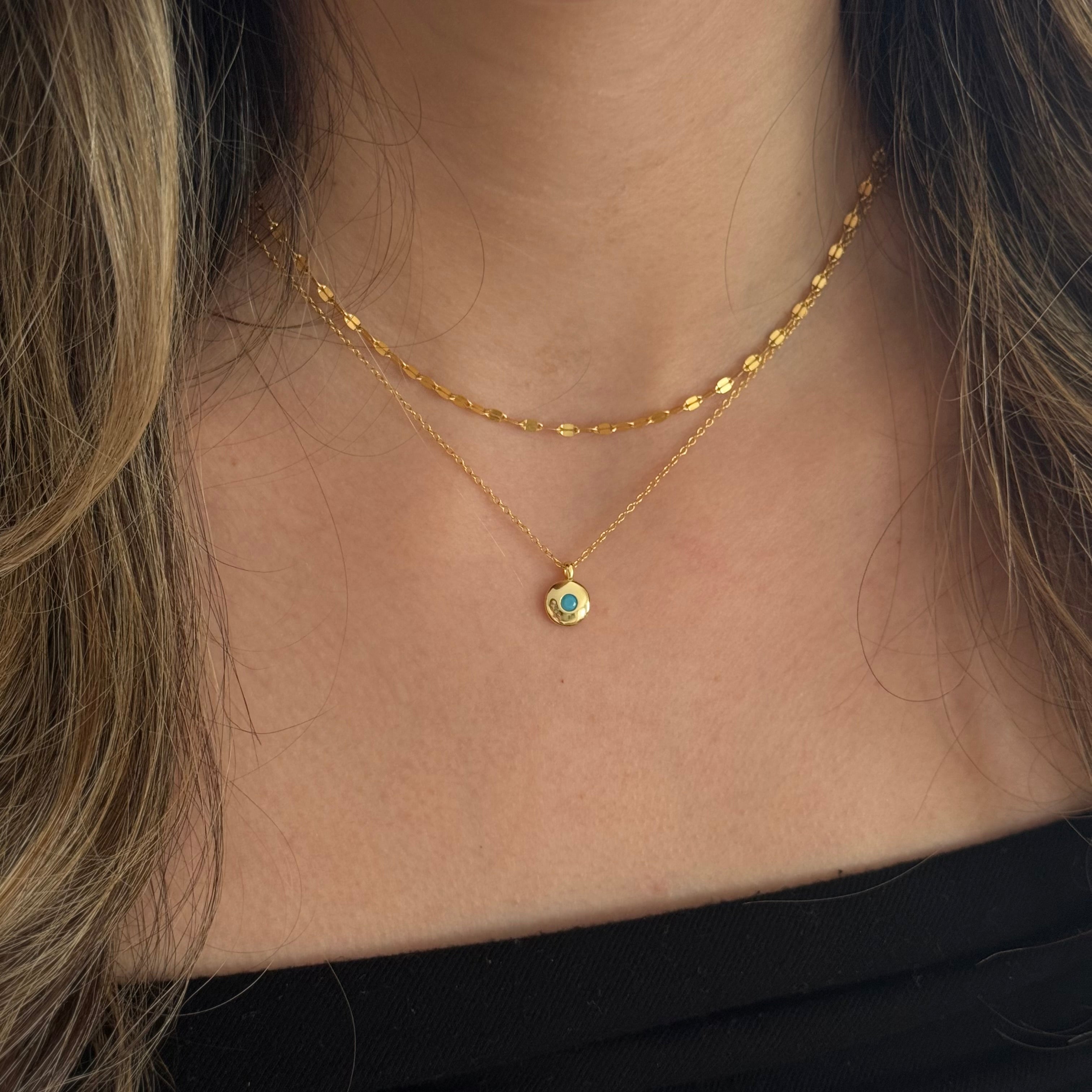 Turquoise gold round pendant necklace worn by model, bright and boho-chic


