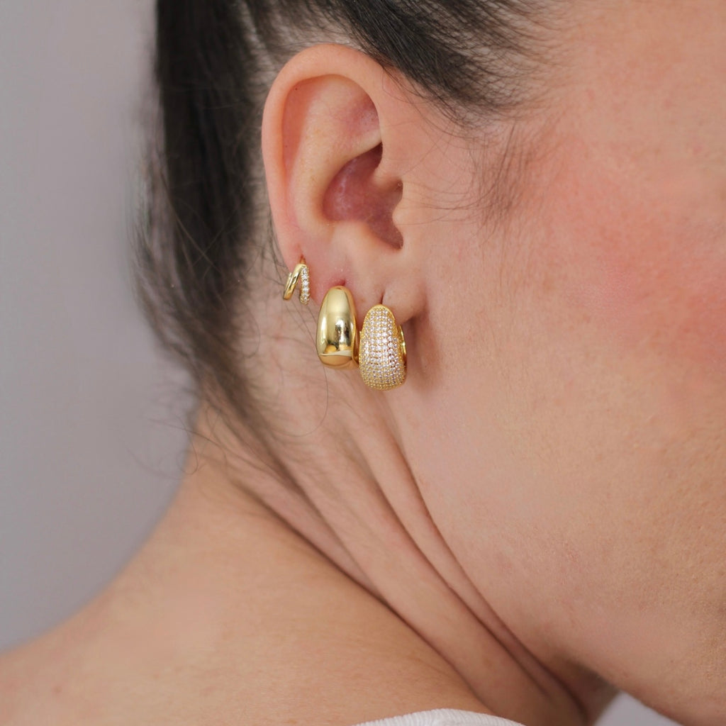 Twin mini huggie earrings worn by model, sleek and minimal look