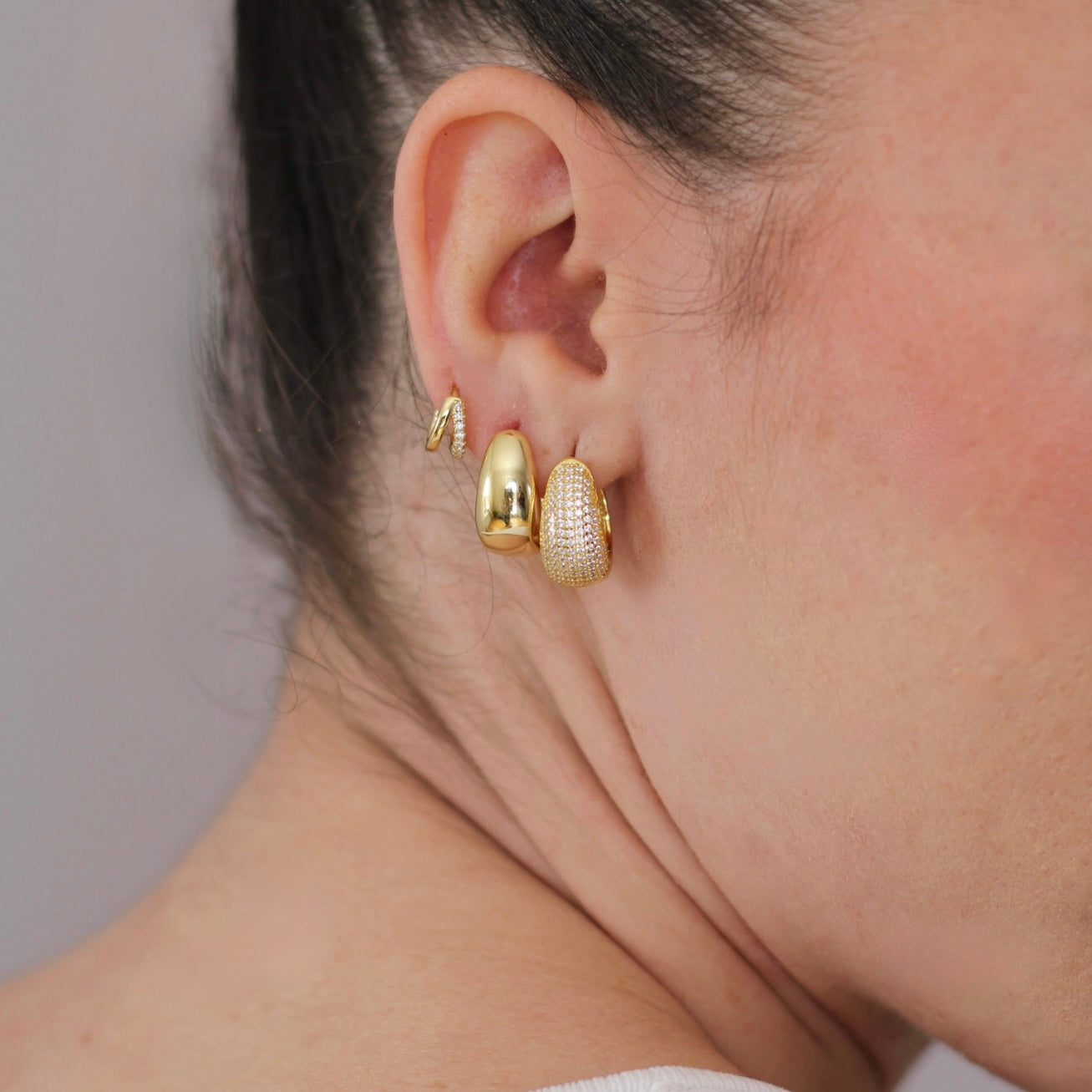 Twin mini huggie earrings worn by model, sleek and minimal look