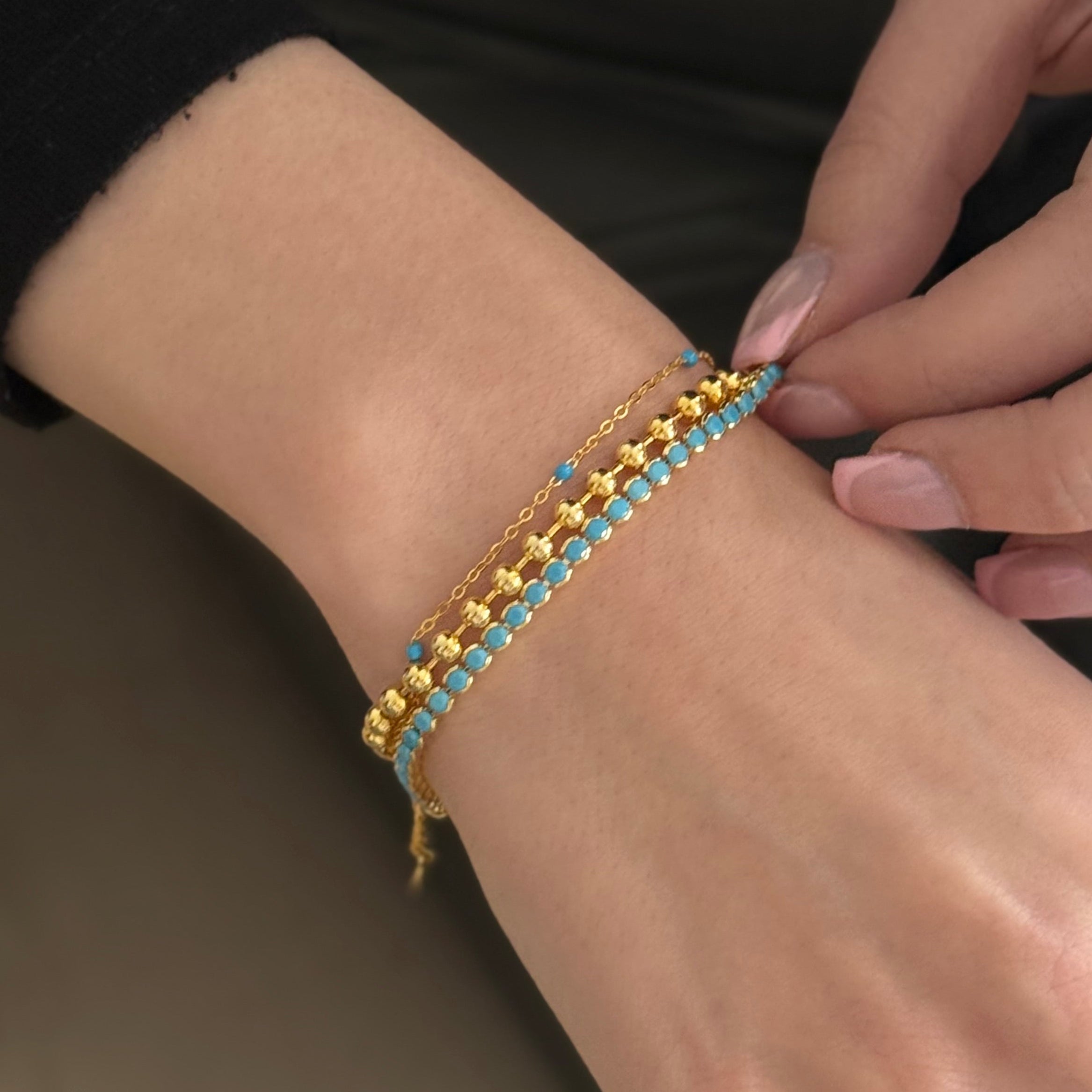 Dainty gold turquoise beaded bracelet worn by model, elegant and minimal