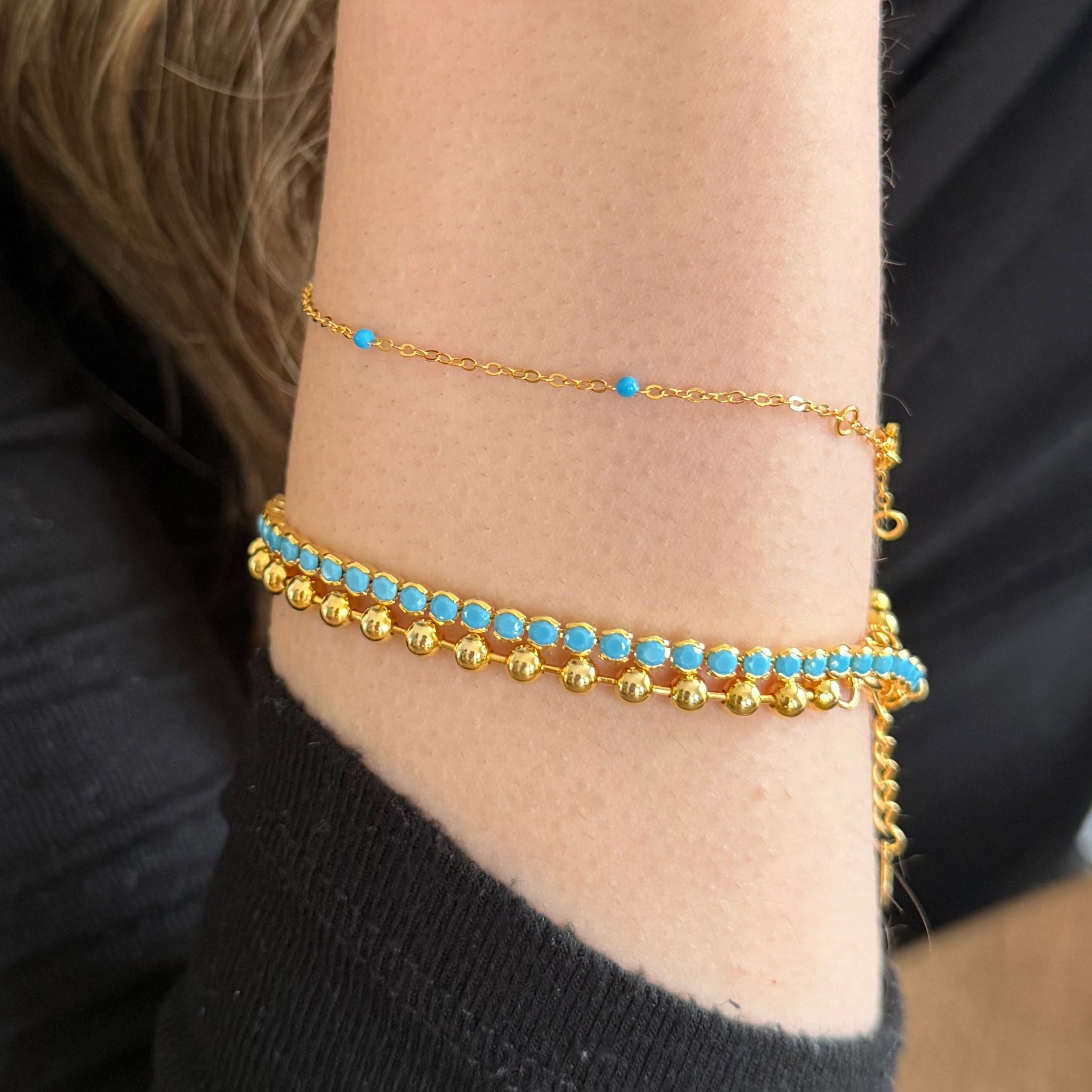 Gold bracelet with turquoise beads styled for everyday wear