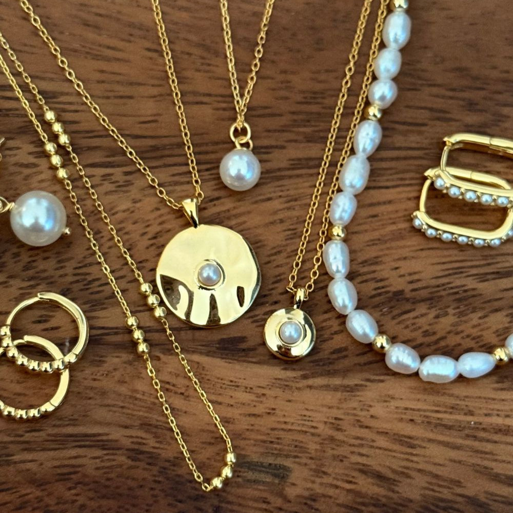  delicate necklaces displayed flat on table surface