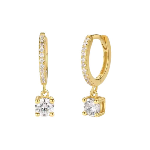 A pair of dainty gold drop earrings with zirconia stones, attached to small hoop closures.